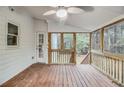 Inviting screened-in porch featuring wood flooring and a ceiling fan at 402 Hancock Ct, Woodstock, GA 30188