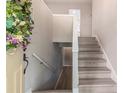 Bright foyer showcasing a staircase with light gray wood steps and an entrance adorned with a floral wreath at 4171 Whispering Forest Sw Ct, Lilburn, GA 30047