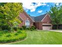 Charming brick home with manicured lawn and mature trees creating an inviting curb appeal at 4584 Brook Farms Dr, Duluth, GA 30096