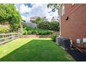 Lush green backyard with meticulously maintained lawn, garden area and fenced perimeter at 5370 Newport Bay Psge, Alpharetta, GA 30005