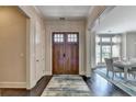Inviting foyer with a wooden front door, hardwood floors, and views into the dining area at 1839 Kent Ave, Atlanta, GA 30338