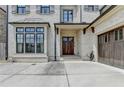 Welcoming entryway with a wood front door, brick facade, and an attached garage at 1839 Kent Ave, Atlanta, GA 30338