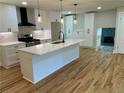 Bright, spacious kitchen with quartz countertops, a large island, and stainless steel appliances at 323 W Claiborne Ct, Marietta, GA 30066