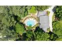 Aerial view of an estate home with an inviting, private pool surrounded by mature trees at 7590 Chaparral Dr, Atlanta, GA 30350
