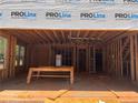 View of new construction of living room with exposed framing, rough cut floors and ladder at 95 Cambridge Dr, Covington, GA 30014