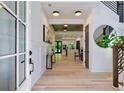 Bright foyer with hardwood floors, modern lighting, and a view into the kitchen that invites exploration at 136 Beutell St, Norcross, GA 30071