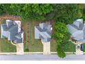 Aerial shot showcasing the home's roof, landscaping, and proximity to surrounding trees at 2994 Meadow Church Rd, Suwanee, GA 30024
