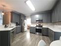 Modern kitchen with stainless steel appliances, subway tile backsplash, and ample counter space at 2994 Meadow Church Rd, Suwanee, GA 30024