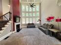 Bright living room with fireplace, large windows, and staircase at 3784 The Great Dr, Atlanta, GA 30349