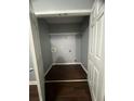Walk in closet with dark wood flooring and built in storage shelf at 3953 Cress Way Run, Decatur, GA 30034