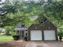 Charming two-story home features a brick facade and a two-car garage at 3953 Cress Way Run, Decatur, GA 30034