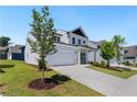 Beautiful two-story home featuring a spacious two car garage and neatly manicured lawn at 803 Levi Farms Ln, Canton, GA 30115