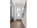 Bright foyer with hardwood floors, a white front door, and a staircase leading to the second floor at 803 Levi Farms Ln, Canton, GA 30115
