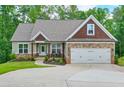 Craftsman style home featuring a two-car garage and a covered porch with beautiful stone and shake accents at 10 Berryhill Se Pl, Cartersville, GA 30121
