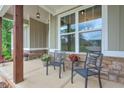 Relaxing front porch with seating, stone accents, and space for potted plants perfect for enjoying the outdoors at 10 Berryhill Se Pl, Cartersville, GA 30121