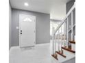 Bright foyer with white marble floors, a staircase, and natural light creates a welcoming atmosphere at 10664 Sandpiper Rd, Jonesboro, GA 30238