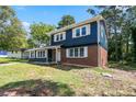 Charming two-story home featuring a blue and brick exterior, well-manicured front lawn, and covered front porch at 10664 Sandpiper Rd, Jonesboro, GA 30238
