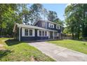 Charming two-story home featuring a blue and brick exterior, well-manicured front lawn, and paved driveway at 10664 Sandpiper Rd, Jonesboro, GA 30238