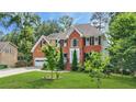 Charming two-story brick home with a well-kept lawn and mature trees in a desirable neighborhood at 2641 Loch Way, Snellville, GA 30039