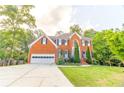Charming two-story brick home featuring a manicured lawn and a spacious driveway at 2641 Loch Way, Snellville, GA 30039