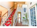Elegant foyer with hardwood floors, staircase with carpet runner, and decorative accents at 2641 Loch Way, Snellville, GA 30039