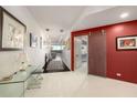 Bright hallway with a decorative sliding door and views to the outside from the end of the hall at 2660 Peachtree Nw Rd # 13H, Atlanta, GA 30305