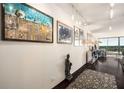 Bright hallway with hardwood floors, modern lighting, and artwork displayed on the walls at 2660 Peachtree Nw Rd # 13H, Atlanta, GA 30305