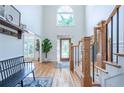 Bright foyer with hardwood floors, a high ceiling, decorative staircase, and a stunning front door at 5589 Forkwood Nw Dr, Acworth, GA 30101