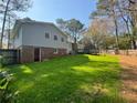 Expansive backyard featuring a well-maintained lawn, wood fencing, and a convenient rear entry at 3210 Ebenezer Rd, Marietta, GA 30066