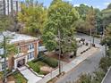 Brick building with a landscaped entrance, showcasing its surrounding street and neighborhood at 242 12Th Ne St # 14, Atlanta, GA 30309