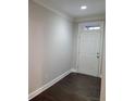 Bright entryway with hardwood floors, white door, and ample lighting at 8265 Village Pl, Suwanee, GA 30024