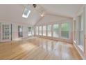 Light-filled sunroom with walls of windows, vaulted ceilings, and hardwood flooring at 915 Chipley Ct, Marietta, GA 30062