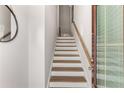 Staircase leads upstairs with wood stairs, white risers, wood handrail and white walls at 1590 Ridgebrook Downs, Mableton, GA 30126