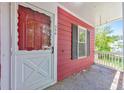 A cozy red house featuring a charming white front porch, an eye catching front door, and black window shutters at 350 Pleasant Oak Sw Ct, Marietta, GA 30008