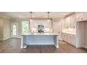 Spacious kitchen with white cabinets, stainless steel appliances, and a center island with pendant lighting at 2462 Adair Ridge Ct, Decatur, GA 30034