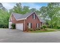 Beautiful brick home with a two-car garage, lush landscaping, and well-maintained grounds at 4355 Old Hamilton Mill Rd, Buford, GA 30518