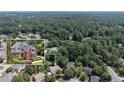 Aerial neighborhood view showcasing the home's location within a lush, wooded community at 4567 Brigade Ne Ct, Roswell, GA 30075