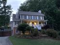 Two-story home with inviting front porch, nestled among mature trees at 1935 Shrader Ct, Lawrenceville, GA 30044