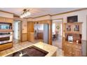 Spacious kitchen with wood cabinets, stainless steel fridge, and adjacent dining area at 1935 Shrader Ct, Lawrenceville, GA 30044