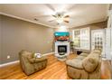 Cozy living room features hardwood floors, a fireplace, and plenty of natural light at 559 Woodland Park Ter, Lawrenceville, GA 30043