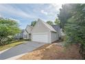View of the driveway with a two-car garage and stone trim. Well-maintained landscape at 861 Soaring Dr, Marietta, GA 30062