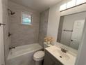 Bright bathroom with a shower-tub combo, updated vanity, and stylish tile at 877 Verona Dr, Clarkston, GA 30021