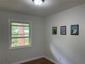 Bedroom with hardwood floors, a bright window, and neutral paint at 877 Verona Dr, Clarkston, GA 30021