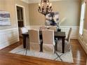 Formal dining room with a dark wood table, upholstered chairs, and a decorative chandelier at 962 Manor Parc Dr, Decatur, GA 30033