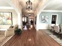 Elegant hallway with hardwood floors, decorative columns, and stylish light fixtures at 962 Manor Parc Dr, Decatur, GA 30033