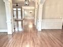 Bright hallway featuring beautiful hardwood floors, and elegant white columns at 962 Manor Parc Dr, Decatur, GA 30033