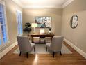 Cozy home office featuring wood floors, a modern desk, and window shutters for natural light at 962 Manor Parc Dr, Decatur, GA 30033