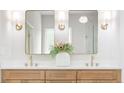 Bathroom with dual sinks, wood cabinets, quartz countertop, and decorative lighting at 1826 Terry Mill Se Rd, Atlanta, GA 30316