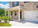 Close-up of the front of a brick home with a covered porch and a two-car garage at 2804 Torunn Ct, Atlanta, GA 30331