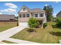 Beautiful two-story home boasts a well-maintained lawn, a two-car garage, and classic architectural details at 3360 Meadow Grass Dr, Dacula, GA 30019